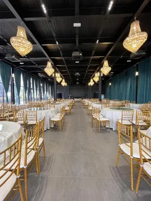 a banquet hall with tables and chairs and chandeliers at MI LE GARDEN Chalet in Sekincan
