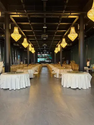 a large banquet hall with white tables and chairs at MI LE GARDEN Chalet in Sekincan