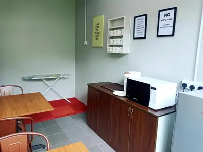 a office with a desk with a computer on it at Bed Station Guest House in Tanah Rata