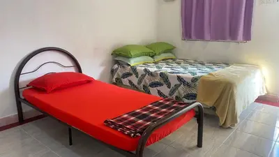 a room with two beds and a red bench at Capital O 91189 Chalet Asyuk Maju in Baling