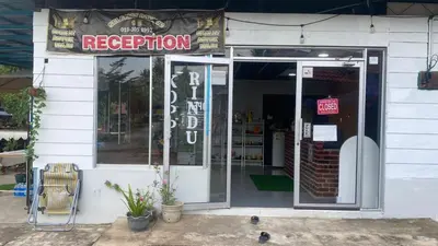 a store with an open door with a sign on it at Capital O 91189 Chalet Asyuk Maju in Baling