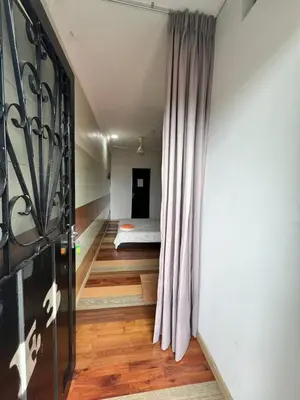 a room with a bed and a window with a curtain at Ting Brother Sg Klah Inn in Sungkai
