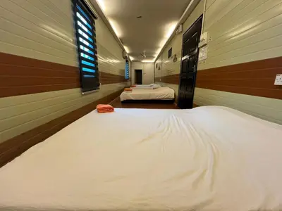 a large white bed in a room with two beds at Ting Brother Sg Klah Inn in Sungkai