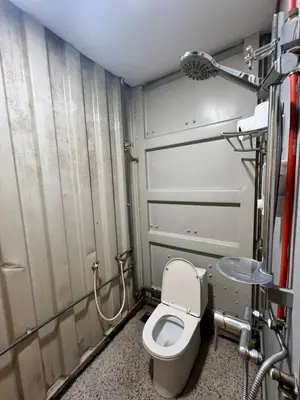 a bathroom with a toilet and a shower at Ting Brother Sg Klah Inn in Sungkai