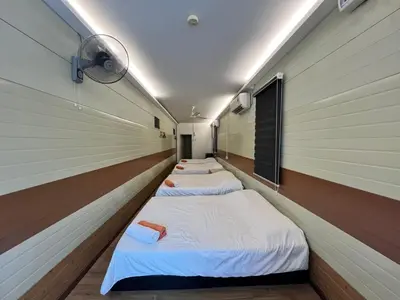 a row of four beds in a room with at Ting Brother Sg Klah Inn in Sungkai