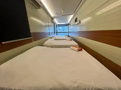 two beds in a small room with at Ting Brother Sg Klah Inn in Sungkai