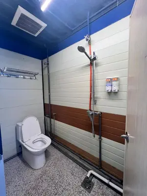 a bathroom with a toilet and a shower stall at Ting Brother Sg Klah Inn in Sungkai