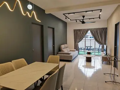 a living room with a table and chairs and a couch at W902WarmStay at EmeraldAvenueBrinchang in Brinchang