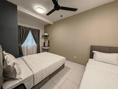 a bedroom with two beds and a ceiling fan at W902WarmStay at EmeraldAvenueBrinchang in Brinchang