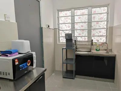 a kitchen with a microwave and a sink and a window at W902WarmStay at EmeraldAvenueBrinchang in Brinchang