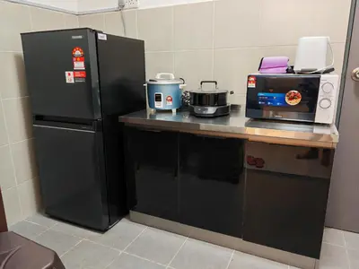 a kitchen with a black refrigerator and a microwave at W902WarmStay at EmeraldAvenueBrinchang in Brinchang