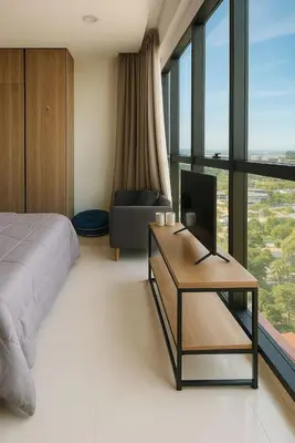 a bedroom with a bed and a desk and a chair at 2 Connecting Room, Kozi Square in Gua Sai