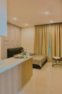a room with a bed and a desk in a room at 2 Connecting Room, Kozi Square in Gua Sai