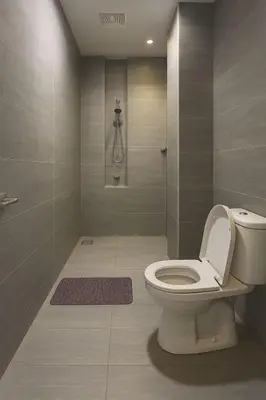 a bathroom with a toilet and a shower at 2 Connecting Room, Riverine Diamond in Gua Sai