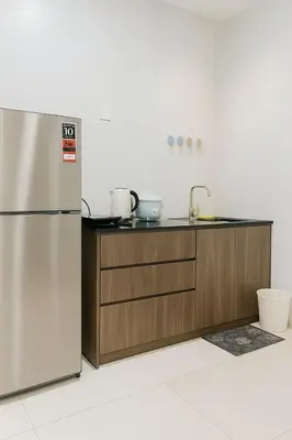 a kitchen with a stainless steel refrigerator and a counter at 2 Connecting Room, Riverine Diamond in Gua Sai
