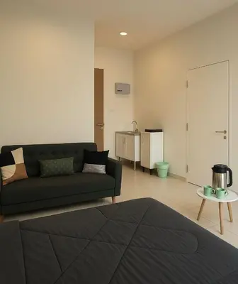 a living room with a couch and a table at 2 Connecting Room, Riverine Diamond in Gua Sai