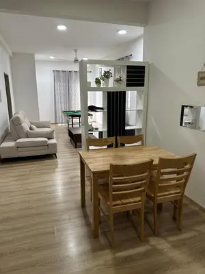 a living room with a table and chairs and a couch at Ayaan Snookers Home 3 at Quintet Apartment with Private Parking in Tanah Rata