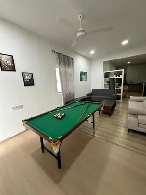 a living room with a pool table and a couch at Ayaan Snookers Home 3 at Quintet Apartment with Private Parking in Tanah Rata