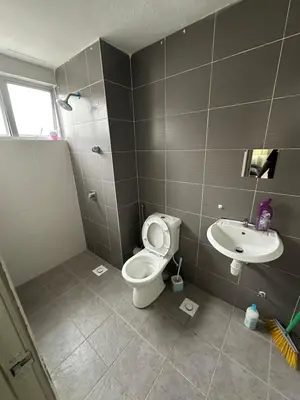 a bathroom with a toilet and a sink at Ayaan Snookers Home 3 at Quintet Apartment with Private Parking in Tanah Rata