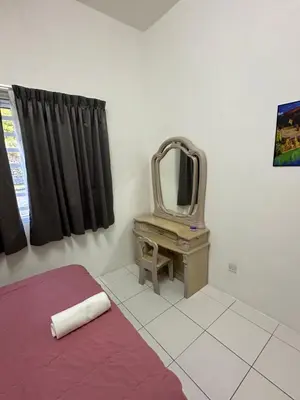 a bedroom with a bed and a mirror on a table at Ayaan Gaming Home 2 Experience Real Life Simulator Racing Games in Tanah Rata