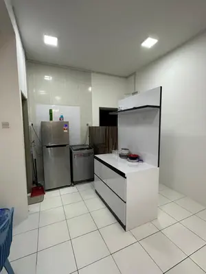an empty kitchen with a refrigerator and a counter at Ayaan Gaming Home 2 Experience Real Life Simulator Racing Games in Tanah Rata