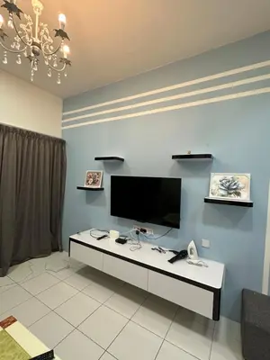 a living room with a tv on a blue wall at Ayaan Gaming Home 2 Experience Real Life Simulator Racing Games in Tanah Rata