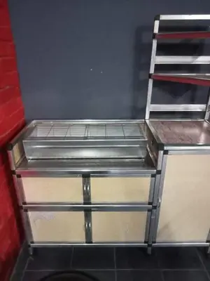 a metal shelf in a kitchen with a counter at Homestay Mariah in Ipoh
