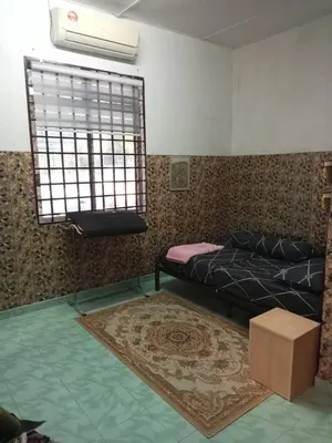 a bedroom with a bed and a window at Homestay Mariah in Ipoh