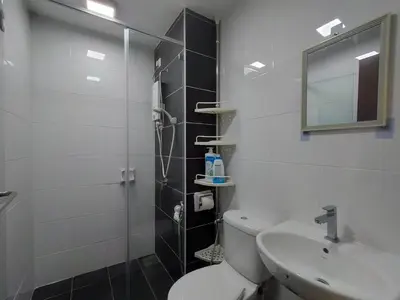a bathroom with a shower and a toilet and a sink at Simple Bali l Projector l Netflix l 2 parking in Ipoh