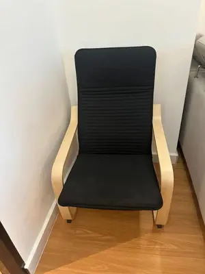 a black chair sitting in the corner of a room at Adik Aisyah black forest luxury cameron homestay in Tanah Rata