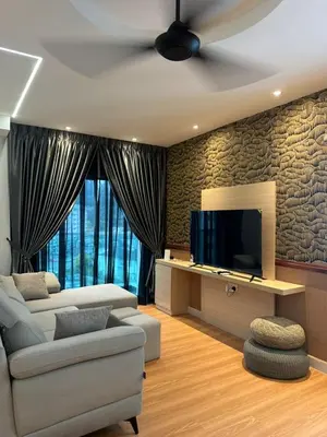 a living room with a couch and a tv at Adik Aisyah black forest luxury cameron homestay in Tanah Rata