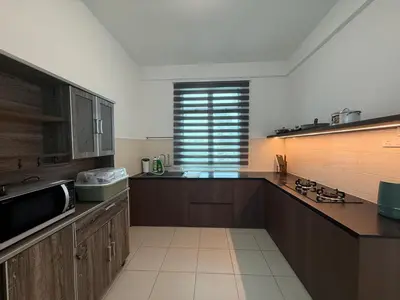 a kitchen with wooden cabinets and a window in it at SPICE Skyview Luxe Tunas 4B3B in Bayan Lepas