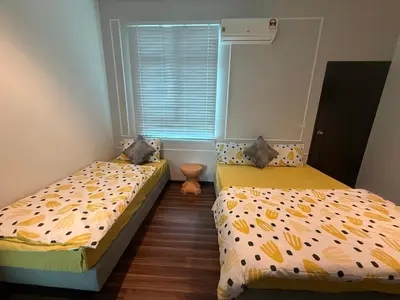 two beds in a room with a window at SPICE Skyview Luxe Tunas 4B3B in Bayan Lepas