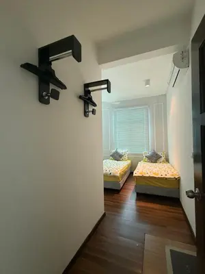 two beds in a room with a hallway at SPICE Skyview Luxe Tunas 4B3B in Bayan Lepas