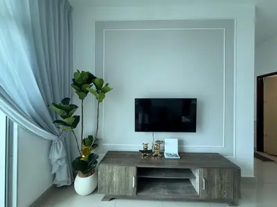 a living room with a tv and a table at SPICE Skyview Luxe Tunas 4B3B in Bayan Lepas