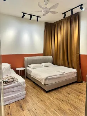 two beds in a room with a ceiling fan at Ayaan Snookers House 2 at Quintet Cameron Highland in Tanah Rata