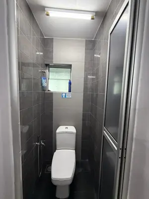 a small bathroom with a toilet and a window at DND Homestay Sitiawan in Sitiawan
