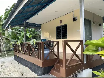a porch of a house with a wooden railing at Homestay Kenangan Kati Kuala Kangsar in Kuala Kangsar