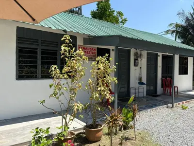 a small white building with a sign on it at Homestay Kenangan Kati Kuala Kangsar in Kuala Kangsar