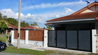 a garage with a black garage door on a house at Homestay Makyu in Kuala Kangsar