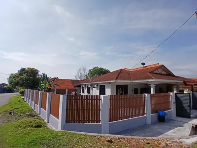 a white fence in front of a house at Homestay Makyu in Kuala Kangsar
