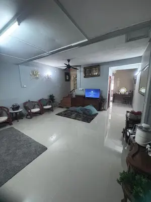 a large living room with a white floor and a ceiling at Homestay Pangkor Ann in Pangkor