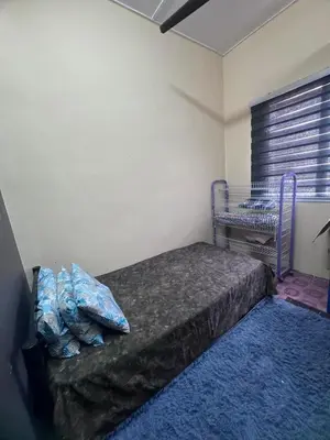 a bedroom with a bed in a room with a window at Homestay Pangkor Ann in Pangkor