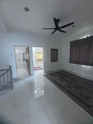an empty living room with a ceiling fan at Homestay Manjung Ann in Seri Manjung