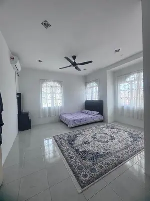 a living room with a bed and a ceiling fan at Homestay Manjung Ann in Seri Manjung