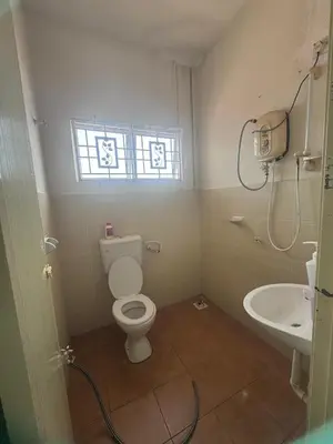 a bathroom with a toilet and a sink at Homestay Manjung Ann in Seri Manjung