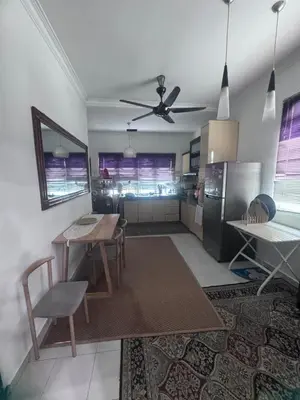 a kitchen with a table and a refrigerator at Homestay Manjung Ann in Seri Manjung