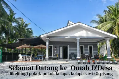 a house on the beach with the words tsunami dancing owl diseaseifting pocket pocket k at Homestay Omah D'Desa with pool in Kampong Telok Ru