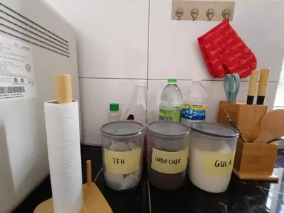 a counter top with a bunch of different ingredients at Homestay Omah D'Desa with pool in Kampong Telok Ru