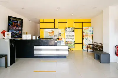 a fast food restaurant with yellow walls and a counter at Golden Roof Hotel Sunway Ipoh in Ipoh